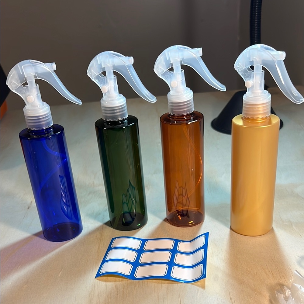 New Set of 4 Spray Bottles in Blue, Green, Amber, and Gold